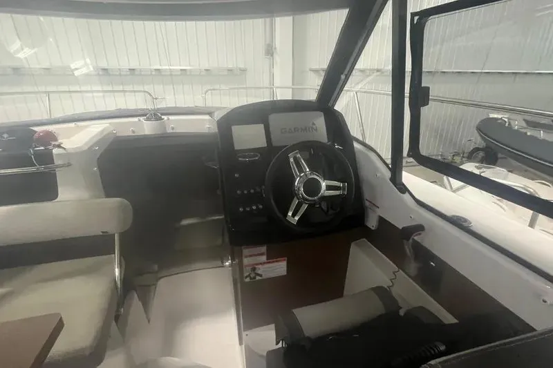 Slide: The Image of Interior view of 2022 Jeanneau NC 795 boat cockpit with Garmin navigation system. - 6