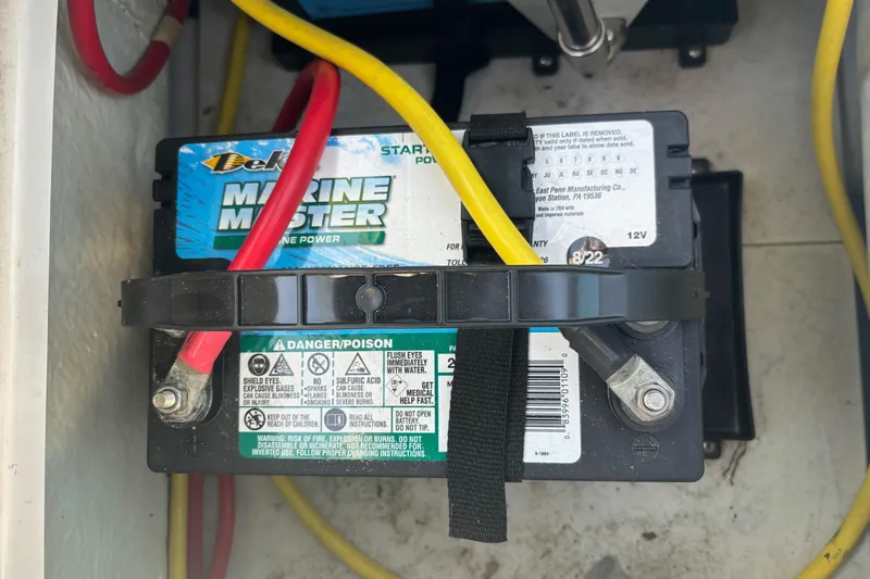 Slide: The Image of Marine battery in a 2016 Four Winns TS222 boat, secured with cables. - 18