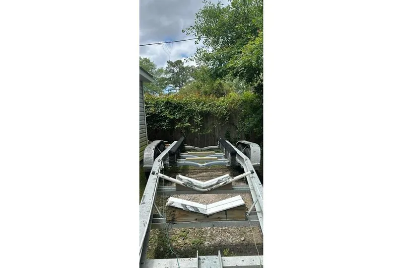 Slide: The Image of Empty boat trailer in a garden setting, suitable for 1989 Grady-White Marlin 280. - 10