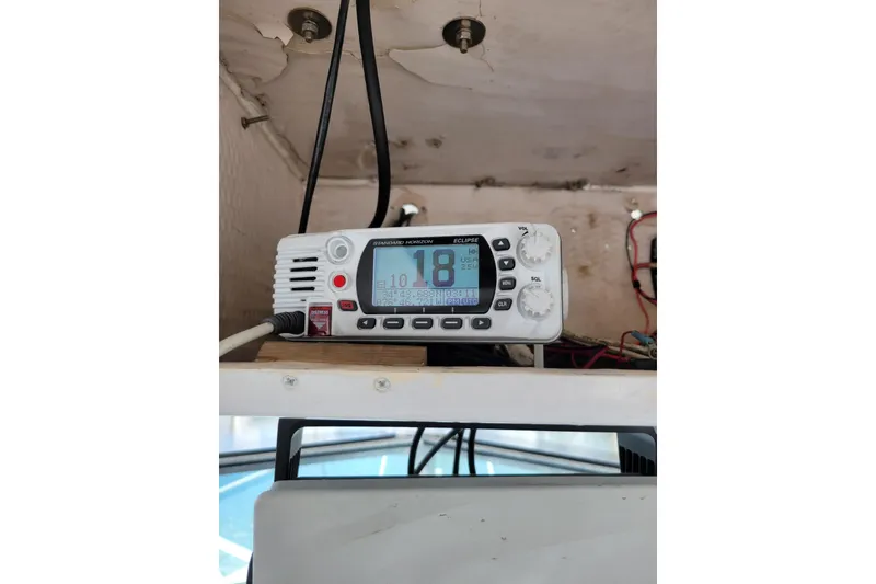 Slide: The Image of VHF radio installed on a 1989 Grady-White Marlin 280 boat dashboard. - 9