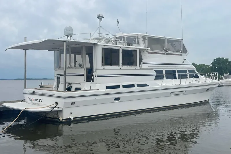 The Image of 2001 Novatec Islander yacht docked on calm water under cloudy skies. - 0