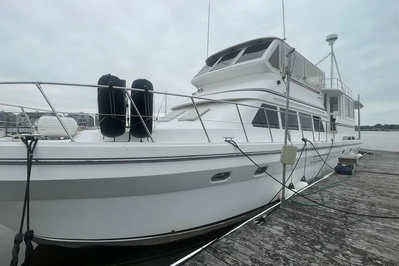 Slide: The Image of 2001 Novatec Islander yacht docked at a marina, showcasing sleek design and spacious deck. - 1