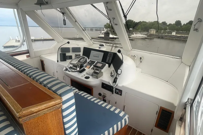 Slide: The Image of Interior view of 2001 Novatec Islander yacht cockpit with striped seating and navigation equipment. - 10