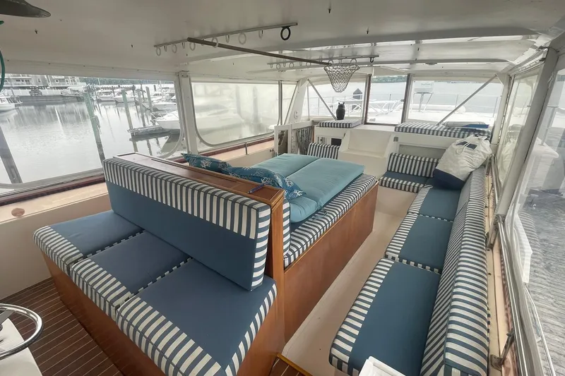 Slide: The Image of Spacious 2001 Novatec Islander yacht interior with striped seating and marina view. - 12