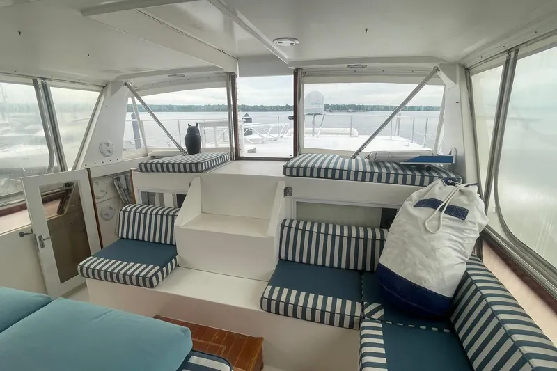 Slide: The Image of Interior of 2001 Novatec Islander yacht with striped seating and large windows. - 13