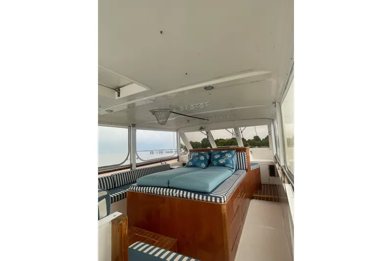 Slide: The Image of Interior of 2001 Novatec Islander yacht with striped cushions and scenic windows. - 17