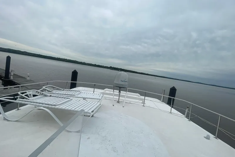 Slide: The Image of Novatec Islander 2001 yacht deck with lounge chairs overlooking calm waters. - 18