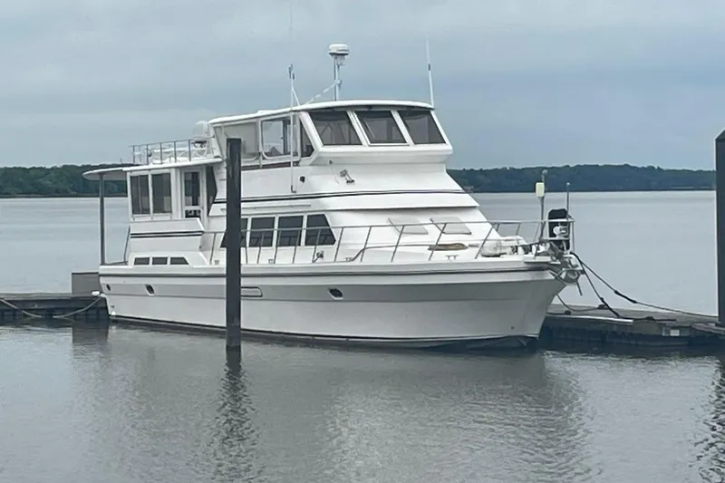 Slide: The Image of 2001 Novatec Islander yacht docked on calm water under cloudy skies. - 2