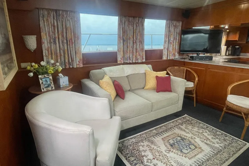 Slide: The Image of Cozy living area on 2001 Novatec Islander yacht with sofa, armchair, and TV. - 20