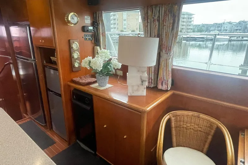 Slide: The Image of Interior of 2001 Novatec Islander yacht with wooden cabinetry, floral decor, and marina view. - 23