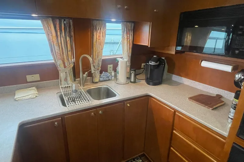 Slide: The Image of Cozy kitchen in 2001 Novatec Islander yacht with sink, microwave, and coffee maker. - 25