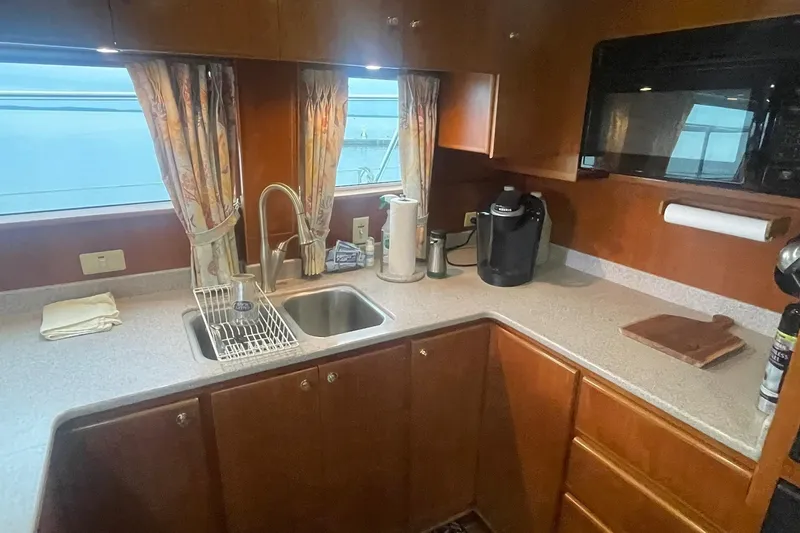 Slide: The Image of 2001 Novatec Islander yacht kitchen with sink, microwave, and coffee maker. - 26