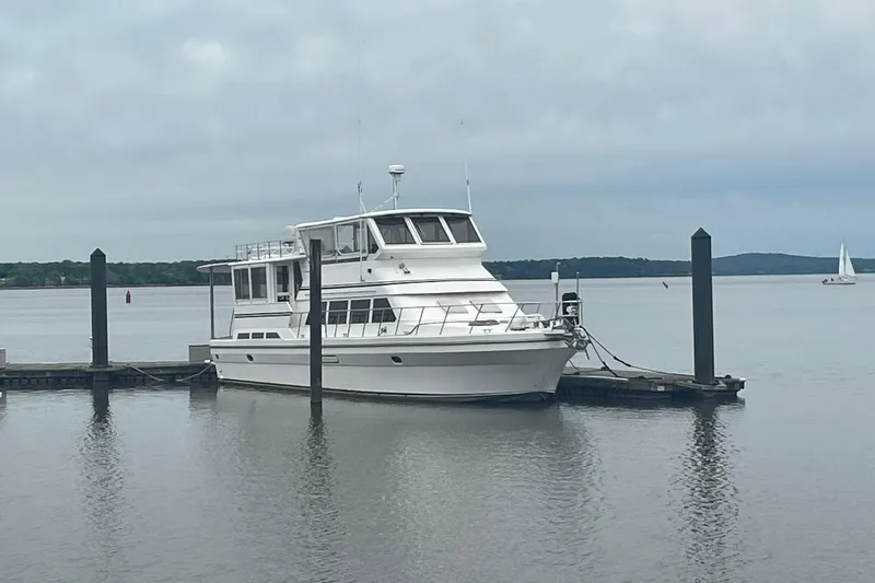 Slide: The Image of Novatec Islander 2001 yacht docked at a serene marina with calm waters. - 3