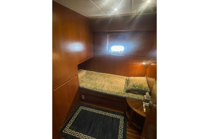 Slide: The Image of Cozy cabin interior of 2001 Novatec Islander yacht with wooden paneling and bedding. - 30