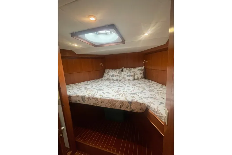 Slide: The Image of Cozy cabin interior of 2001 Novatec Islander yacht with patterned bedding. - 33