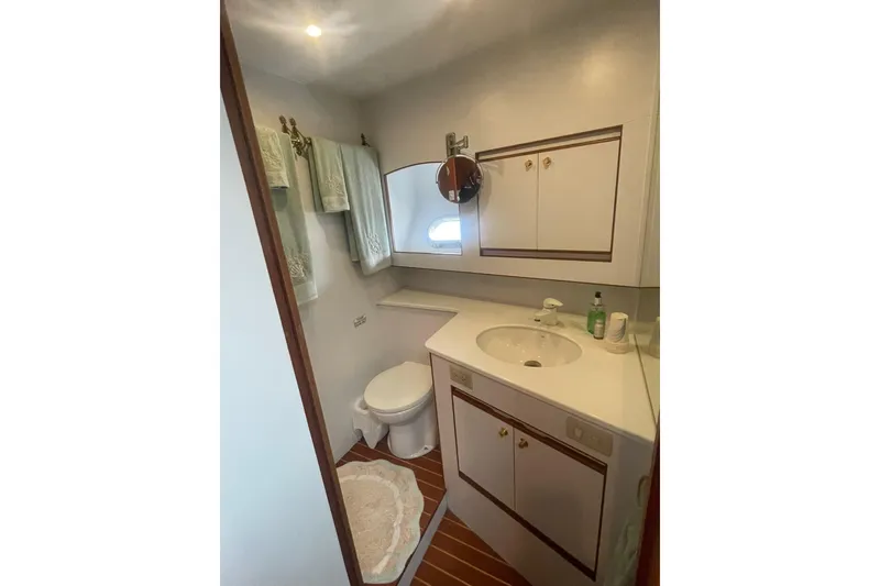 Slide: The Image of Bathroom interior of 2001 Novatec Islander yacht with sink, toilet, and storage cabinets. - 34
