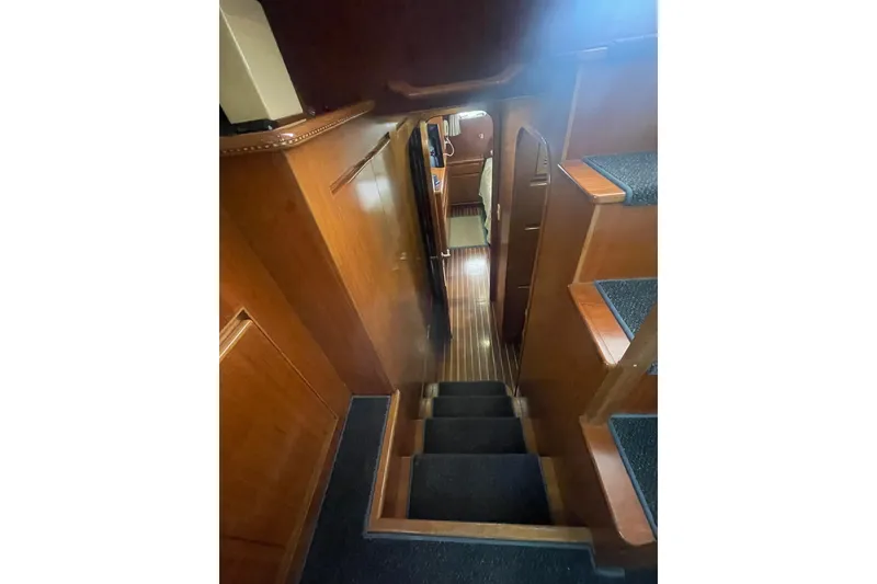 Slide: The Image of Interior view of 2001 Novatec Islander yacht with wooden stairs and hallway. - 36