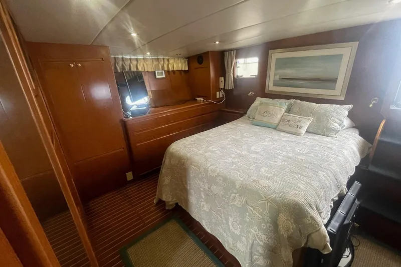Slide: The Image of Cozy bedroom in 2001 Novatec Islander yacht with wood paneling and nautical decor. - 39