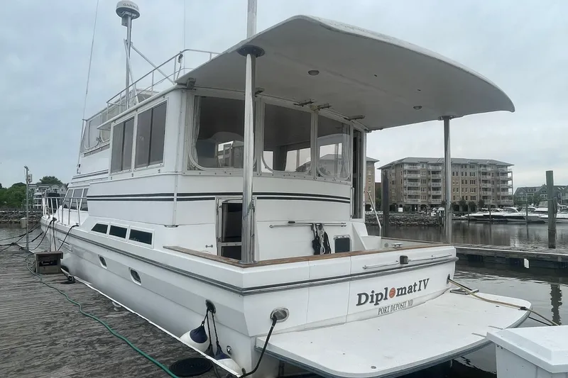 Slide: The Image of Novatec Islander 2001 yacht docked at marina, featuring spacious deck and modern design. - 4