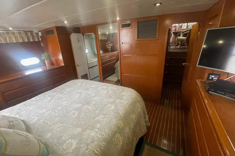 Slide: The Image of Luxurious 2001 Novatec Islander yacht bedroom with elegant wood paneling and cozy bedding. - 40