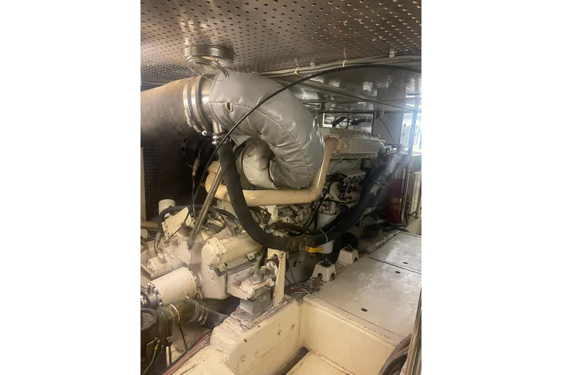 Slide: The Image of Engine room of a 2001 Novatec Islander yacht, showcasing machinery and exhaust system. - 45