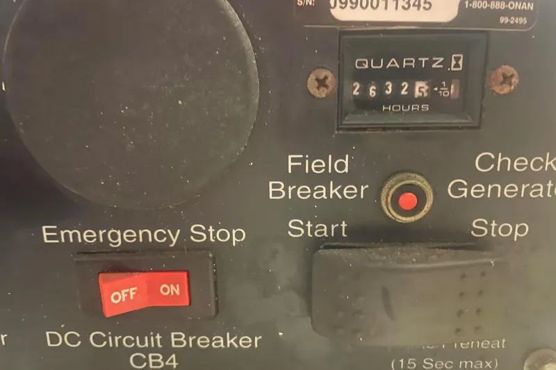 Slide: The Image of Control panel of a 2001 Novatec Islander with emergency stop and hour meter. - 49