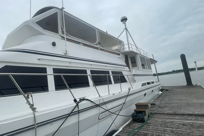 Slide: The Image of 2001 Novatec Islander yacht docked at a wooden pier on a cloudy day. - 5