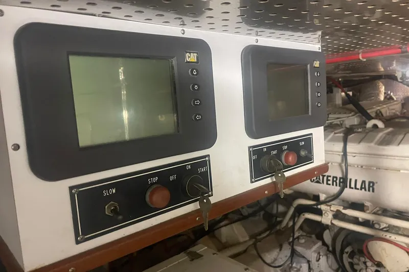 Slide: The Image of Control panel of a 2001 Novatec Islander boat with Caterpillar engine displays. - 52
