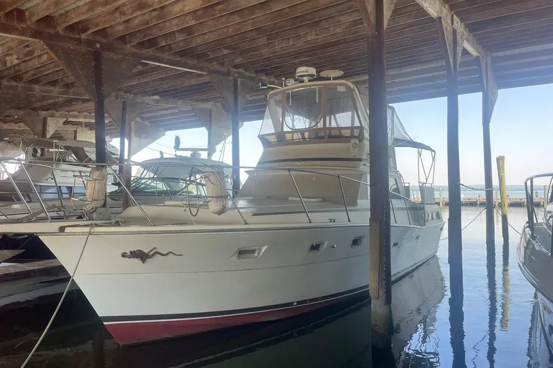 Slide: The Image of 2001 Novatec Islander yacht docked under a wooden shelter. - 55
