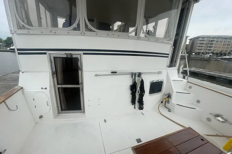 Slide: The Image of 2001 Novatec Islander boat deck with steps, docked at marina. - 8
