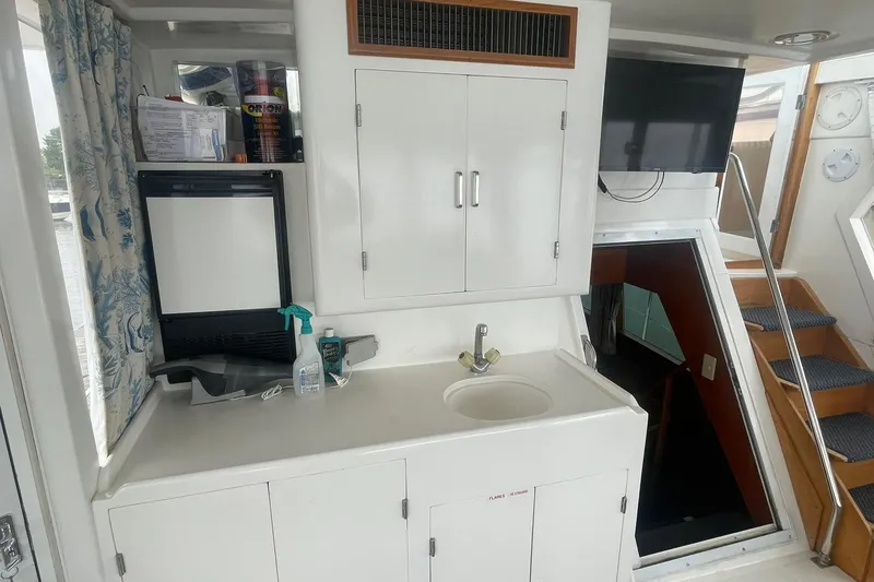 Slide: The Image of Interior of a 2001 Novatec Islander boat with sink, cabinets, and TV. - 9