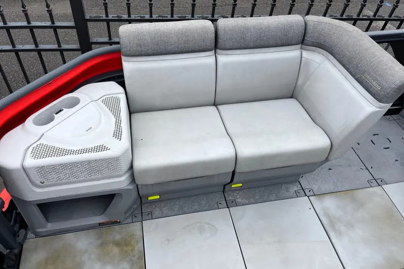 Slide: The Image of 2022 Sea-Doo Switch Cruise 21 boat seating area with gray upholstery and storage compartment. - 3
