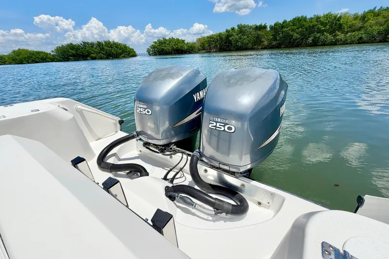 Slide: The Image of Twin Yamaha 250 engines on a 2007 Edgewater 268CC boat, surrounded by serene waters. - 10