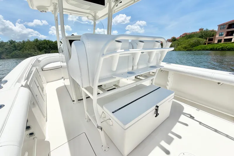 Slide: The Image of 2007 Edgewater 268CC boat interior with seating and storage, set against a scenic water backdrop. - 13