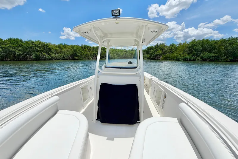 Slide: The Image of 2007 Edgewater 268CC boat on calm water, surrounded by lush greenery and blue sky. - 21