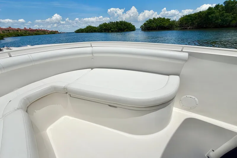 Slide: The Image of Bow seating area on a 2007 Edgewater 268CC boat, overlooking calm waters and lush greenery. - 24