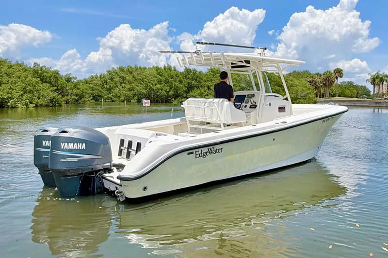 Slide: The Image of 2007 Edgewater 268CC boat with dual Yamaha engines on a calm waterway. - 4