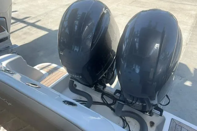 Slide: The Image of 2017 Chris-Craft Calypso 26 with dual outboard engines, docked on a sunny day. - 10