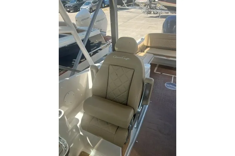 Slide: The Image of Luxurious seating on a 2017 Chris-Craft Calypso 26 boat, featuring elegant tan upholstery. - 17