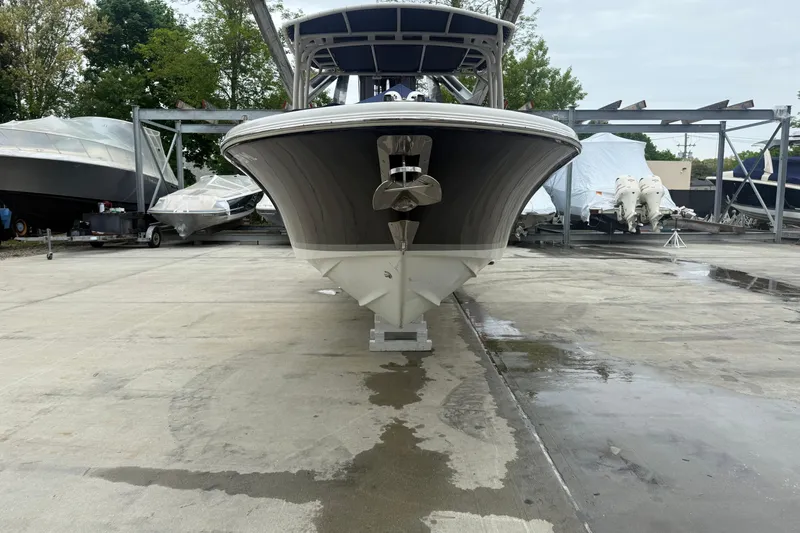 Slide: The Image of 2017 Chris-Craft Calypso 26 boat on dry dock, surrounded by other vessels. - 2