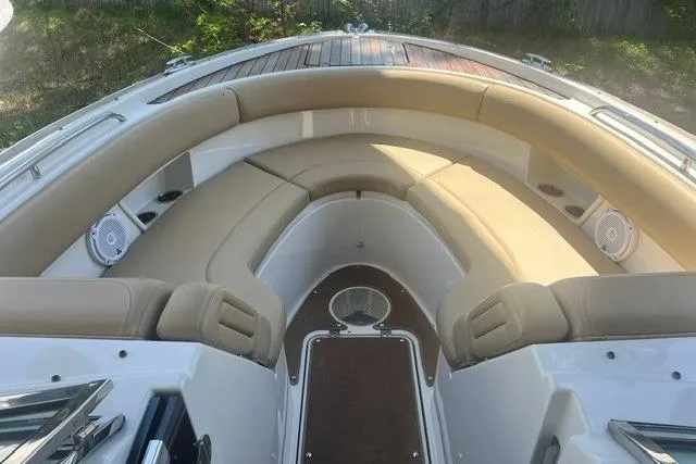 Slide: The Image of 2017 Chris-Craft Calypso 26 boat interior with beige seating and wood accents. - 27
