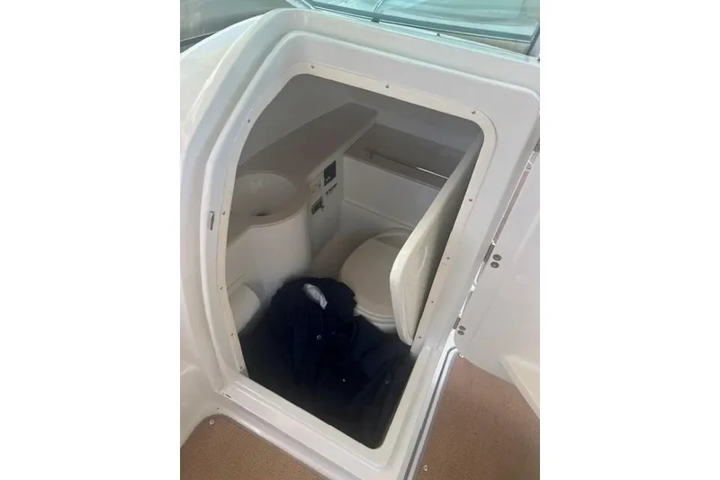 Slide: The Image of 2017 Chris-Craft Calypso 26 boat interior with compact bathroom area. - 28