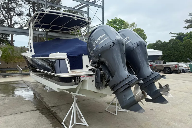 Slide: The Image of 2017 Chris-Craft Calypso 26 boat with twin Yamaha outboard engines on a trailer. - 3