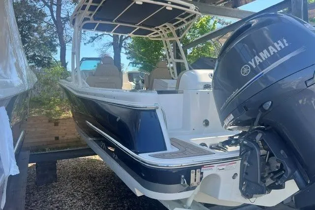 Slide: The Image of 2017 Chris-Craft Calypso 26 boat with Yamaha outboard motor, docked outdoors. - 7