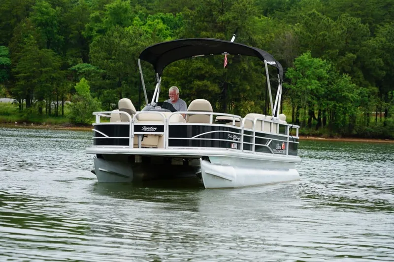 Slide: The Image of 2016 Sun Tracker Fishin' Barge 20 DLX pontoon boat on a serene lake. - 2