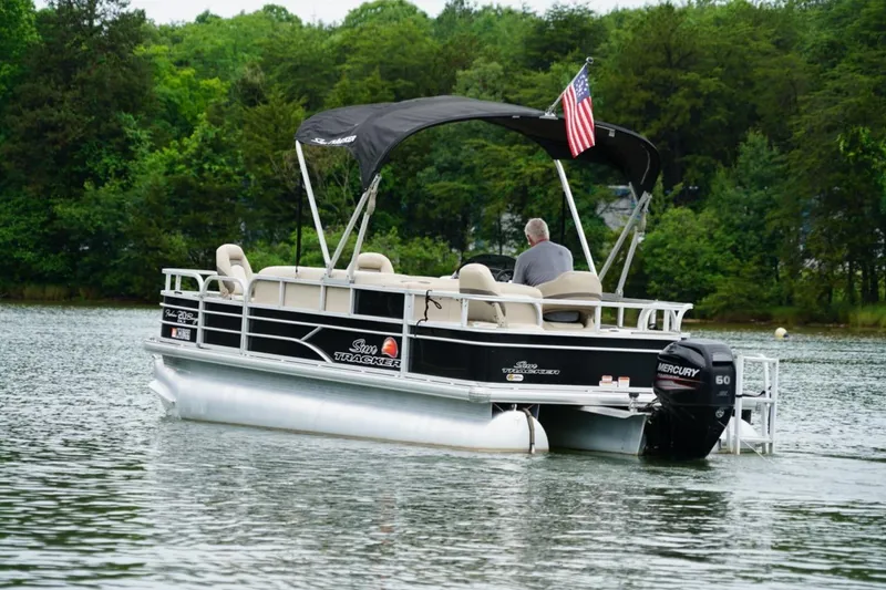 Slide: The Image of 2016 Sun Tracker Fishin' Barge 20 DLX pontoon boat on a serene lake. - 3