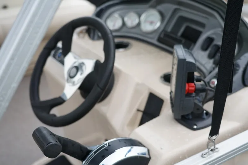 Slide: The Image of 2016 Sun Tracker Fishin' Barge 20 DLX steering console with controls and gauges. - 5
