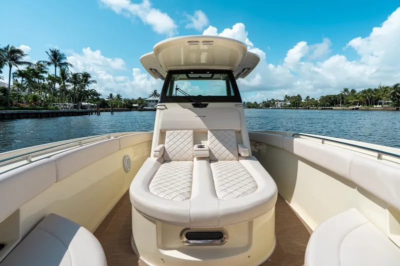 Slide: The Image of 2024 Chris-Craft Catalina 30 boat interior with luxurious seating, set against a scenic waterfront. - 13