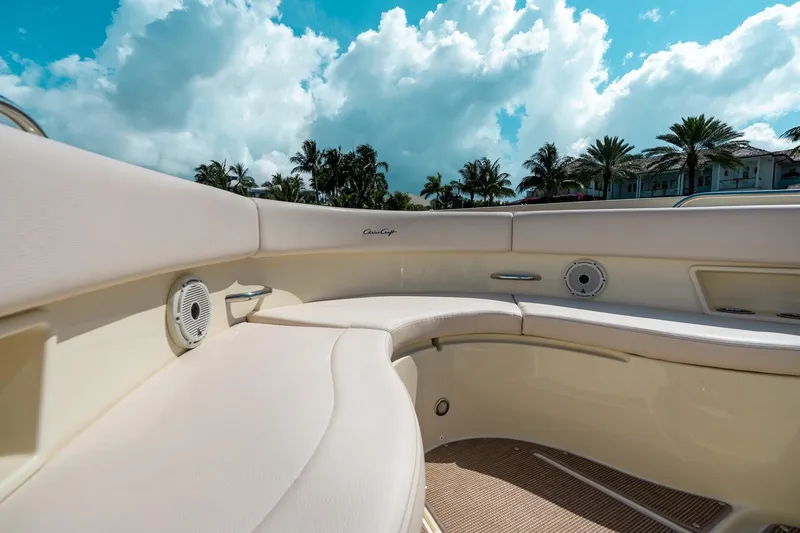 Slide: The Image of 2024 Chris-Craft Catalina 30 interior with luxurious seating and scenic palm tree backdrop. - 14