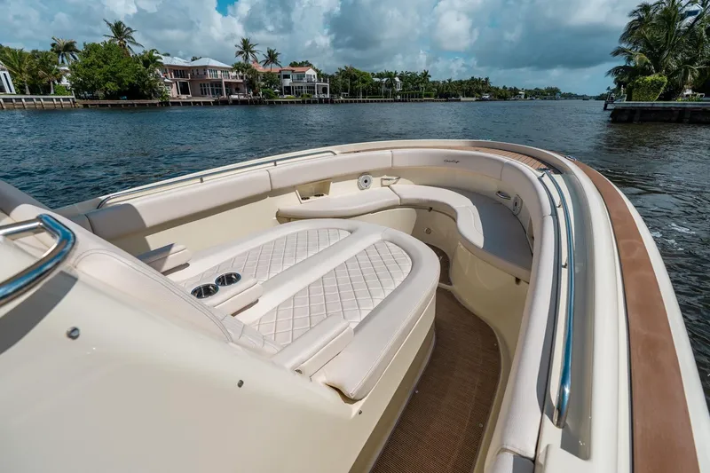 Slide: The Image of 2024 Chris-Craft Catalina 30 boat with luxurious seating on a scenic waterway. - 15